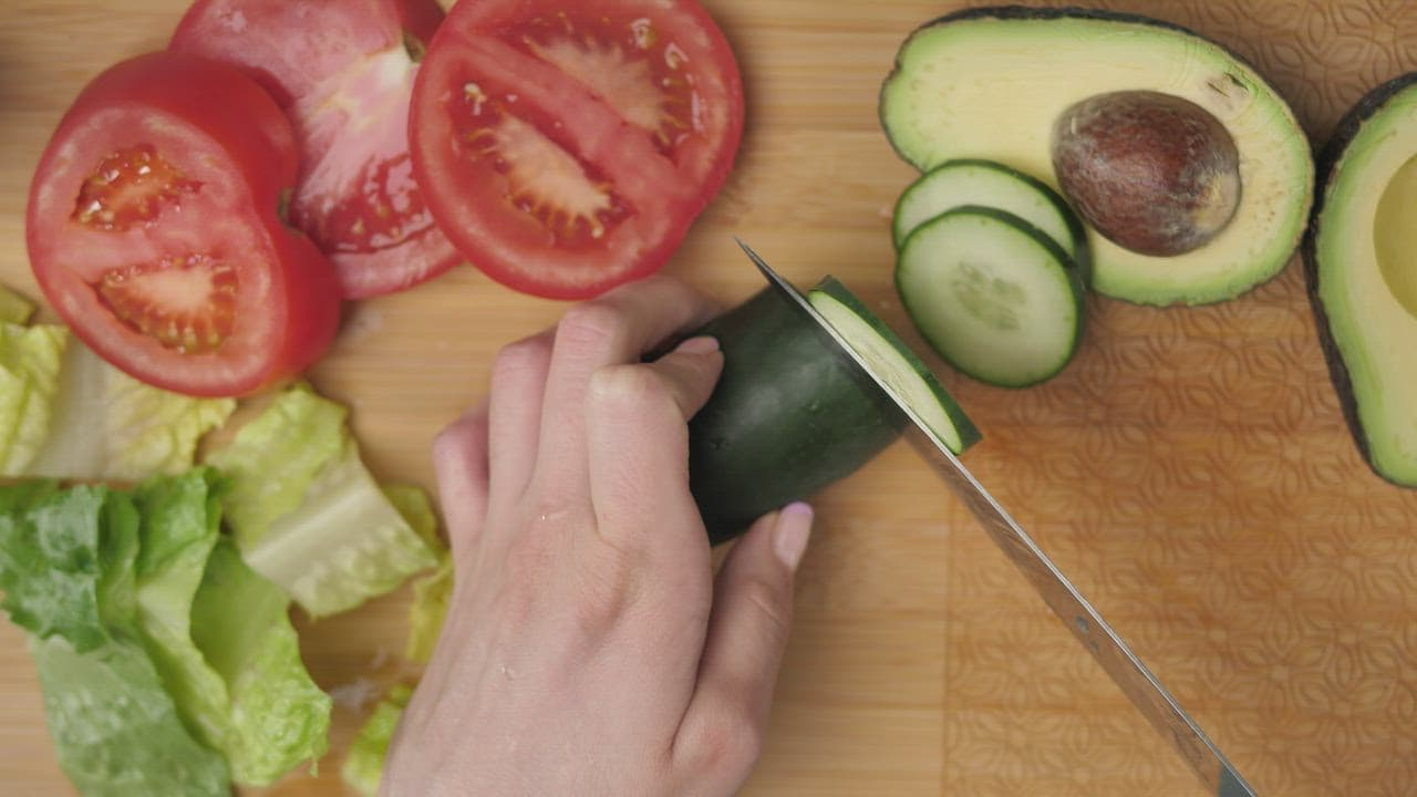 Chopping fresh vegetables on a cutting board