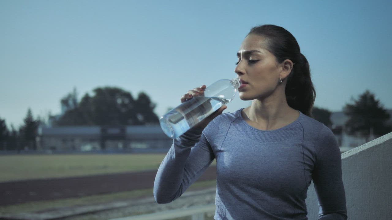 Woman drinking water after a workout