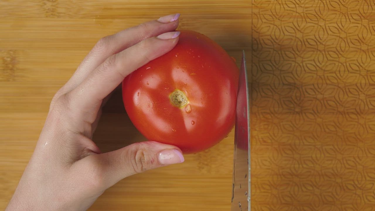 Slicing a ripe tomato